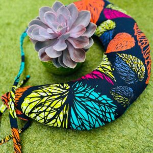 African print neck pillow styled with succulent plant for comfort travel and relaxation