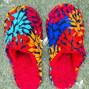 Indoor slippers made from reclaimed fabric offcuts with a soft fleece lining designed for warm comfortable wear at home.