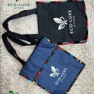 EcoLuxe branded reusable tote bags in navy and black with patterned trim.