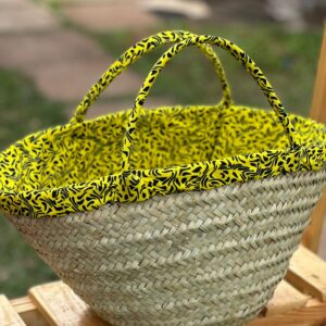 Handwoven natural fiber basket with bright African print fabric lining for sustainable gifting and storage